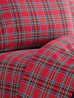 red and blue plaid bedding with matching pillow cases on top of eachother