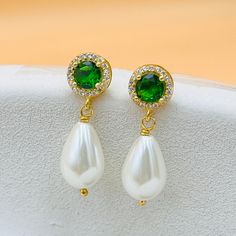 ✨ A unique gift for your loved ones with these elegant earrings, handcrafted from stunning emeralds and teardrop pearls.  ✨ A wonderful jewel that will attract attention on your special occasions. The Emerald pearl earring features a round emerald at the top,  elegantly paired with a shiny teardrop pearl at the bottom, creating a unique and elegant design. ✨ These 2.5cm long earrings are the perfect statement piece for any occasion. ✨ Whether for your mother, grandmother or sister, these earring Elegant Green Round Bridal Earrings, Elegant Pear-shaped Emerald Earrings, Green Dangle Pearl Earrings For Anniversary, Green Pearl Drop Earrings For Anniversary, Green Pearl Drop Earrings As Gift, Green Pearl Drop Earrings For Gift, Green Round Classic Pearl Earrings, Classic Green Pearl Drop Jewelry, Green Teardrop Pearl Earrings For Wedding