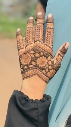 a woman's hand with henna on it