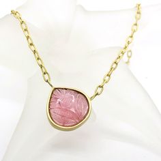 A large, carved pink Tourmaline encased in a handmade bezel suspended on an 18 karat yellow gold chain. The twisted chain has large oval links which can be used to adjust the length from 18 1/2 inches. A one-of-a-kind, handmade piece that is comfortable for everyday and dressy for a special occasion. 14.63-carat pink Tourmaline pear or drop shape, measures around 9.8 x 8.8mm hand carved - floral motif conflict-free - eco friendly 18 karat yellow gold 18 1/2 inches long - adjustable Mindfully cra Yellow Gold Oval Necklace With Intaglio, Formal Pink Cabochon Necklace, Pink Tourmaline Beaded Necklaces, Yellow Gold Tourmaline Pendant Necklace, Handmade Pink Tourmaline Necklaces, Pink Emerald-cut Tourmaline Jewelry, Pink Tourmaline Pendant, 18k Gold Necklace, Tourmaline Necklace