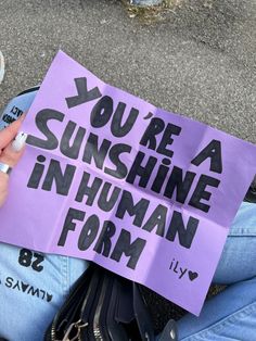 someone holding up a sign that says you're sunshine in human form