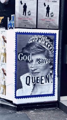 there is a poster on the side of a building that says god save the queen