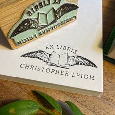 a rubber stamp with an eagle and the words ex libris christoperer leigh on it