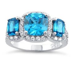 Top of ring height: 10.7mm

Top of ring width: 20mm

Band width: 4.7mm

Shank width: 2.4mm



Stone material: blue & clear cubic zirconia

Center stone size: 8mm

Stone shape: cushion cut (center) & round

Center stone carat weight: 2 ct.

Total number of CZ stones: 45

Stone setting: prong setting



Metal: 925 sterling silver

Plating: rhodium plated

Finish: high polish Stone Material, Stone Setting, Cz Ring, Blue Topaz Ring, Topaz Ring, Cz Stone, Three Stone, Cushion Cut, Stone Settings