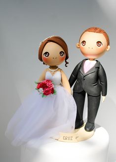 a bride and groom figurine on top of a cake