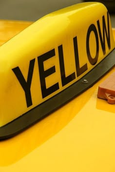 a yellow hat with the word yellow on it sitting on top of a wooden table