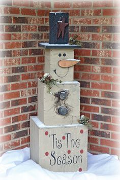 a wooden block with a snowman made out of it and the words tis the season written on it