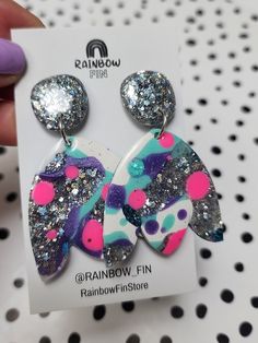 At Rainbow Fin I hand make unique handcrafted, earrings made from resin and mixed media.  All earrings are handmade with love may feature slight imperfections and inconsistencies. I only list items that I would wear myself.  Please be aware that the colours may display differently on computer/phone screens and monitors. Every attempt has been made to represent the product and colours as accurately as possible. Trendy Handmade Iridescent Earrings, Artsy Resin Dangle Earrings, Handmade Multicolor Earrings For Birthday, Artistic Multicolor Resin Earrings, Blue Sparkles, Lovely Earrings, Cute Earrings, Resin Crafts, Jewelry Earrings Dangle