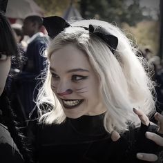 two women dressed up as cats with fake teeth