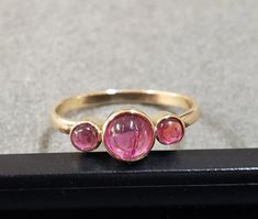 -PRODUCT TYPE - 18K GOLD PINK TOURMALINE RING -MATERIAL - GOLD -PURITY - 18K -STONE WEIGHT - 0.95 CARAT                     -GOLD WEIGHT - 1.790 GRAMS APPROX -TOTAL WEIGHT - 1.980 GRAMS APPROX -STONE - PINK TOURMALINE  -STONE SIZE - 5 MM    -BAND SIZE - 2 MM We are Introducing this new collection of Silver jewelry which is distinctive and unique. We have used natural White Pink Tourmaline of superb quality. So, here We launch this item on etsy!  If You are looking for any other sizes which are not available in variation category do contact us directly.  Anirudh Gems Store :- https://www.etsy.com/uk/shop/ANIRUDHGEMSStore?ref=search_shop_redirect -Quality is guaranteed. Our mission is always to satisfy our customers with our offerings, so just relax and place order! Gold Jewelry Gift, Gem Store, Pink Tourmaline Ring, Pink Shade, Gift Love, Cabochon Ring, Tourmaline Stone, Tourmaline Ring, Valentine's Gift