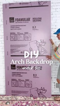 a woman standing in front of a poster with the words diy arch back drop