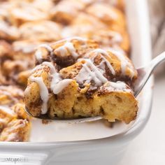 a spoonful of cinnamon roll casserole with icing