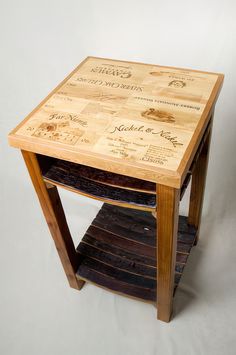 a small wooden table with wine corks on the top and bottom shelf for storage