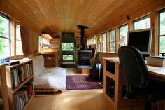 a living room filled with furniture and bookshelves next to a fire place in a house