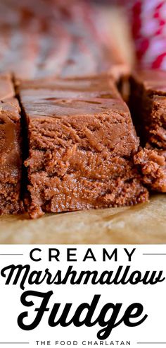 a close up of some brownies with the words creamy marshmallow fudge