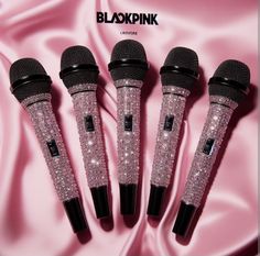 three microphones are lined up on a pink satin background with the words bloxpink written in black