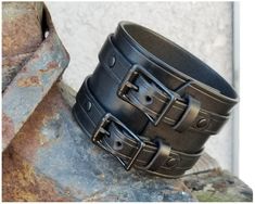 We need your WRIST MEASUREMENT. Not total length! This BLACK leather cuff with the Black Buckles is a fantastic classic look with modern styling and high end quality. This is a truly special statement piece awesome worn individually or completely badass worn as a pair. It is a substantial but still Leather Cuff Men, Mens Leather Jewelry, Leather Cuff Bracelets, Fairy Bracelets, Leather Wrist Cuff, Wrist Wallet, Genuine Leather Bracelet, Hand Accessories, Leather Wristbands