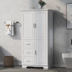 a bathroom with a toilet, sink and white cabinet in the corner by the wall