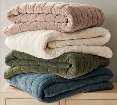 four blankets stacked on top of each other