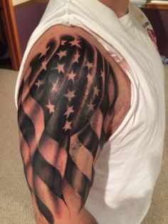 a man's arm with an american flag tattoo on it