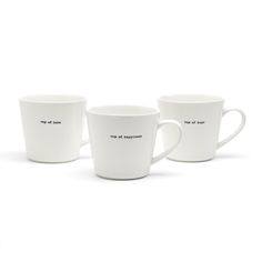 three white coffee mugs with words on them