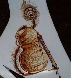 a drawing of a vase with a feather on it and a pen next to it