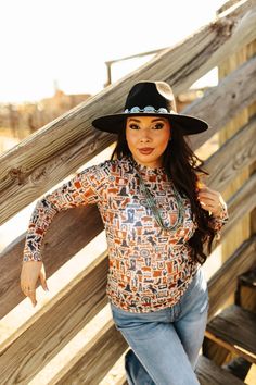 Our Wild West Long Sleeve Mesh Top is as bold and eclectic as the untamed frontier. The fun design boasts lawman badges, coyotes, jackrabbits, oil derricks, cacti, and much more in indigo blue and rustic burnt orange colors. Crafted from breathable mesh, it's versatile enough to keep you cool or to layer under your favorite jacket for warmth. Western Brown Tops For Winter, Brown Western Tops For Winter, Brown Western Style Top For Winter, Fall Festival Tops With Graphic Print, Long Sleeve Tops For Western-themed Fall Events, Festival Graphic Print Tops For Fall, Graphic Print Tops For Fall Festival, Western Tops For Rodeo In Fall, Western Style Tops For Rodeo In Fall