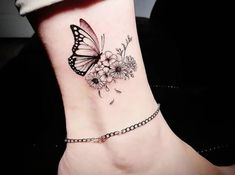 a butterfly and flowers tattoo on the ankle