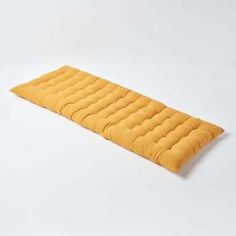 an orange sleeping mat on a white background with no one around it or someone else