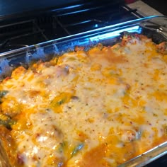 a casserole dish with cheese and other toppings in a glass baking pan