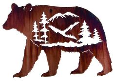 a metal bear with trees and mountains on it