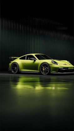 a lime green sports car parked in front of a metal wall with lights on it