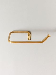 a pair of gold colored handles on a white surface