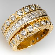 This captivating wide band style ring is accented with thirty-two (32), channel set, baguette cut diamonds and thirty-six (36), semi-bezel set, round brilliant cut diamonds. The ring measures 12.4mm at the top, rises 4.1mm above the finger, tapering to 10.0mm wide and 1.7mm thick at the base of the shank. This ring is currently a size 5.75 and can safely be resized only between size 5.5 and 6. Wide Diamond Wedding Bands, Wide Band Diamond Rings, Wedding Rings Emerald Cut, Rings Emerald, Wide Wedding Bands, Wide Band Ring, Baguette Cut Diamond, Wide Band Rings, Dress Rings