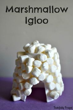 marshmallow igloo is sitting on top of a purple surface with the words marshmallow iglo above it