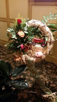 a bouquet of flowers is sitting on a table with a toy truck in the center