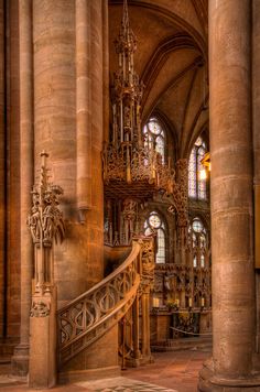 the inside of a large cathedral with many windows and stairs leading up to an altar