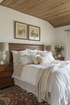 a bed with white linens and pillows in a bedroom next to a window covered by curtains