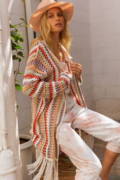 With its lovely colorway that has been nicely weaved, this cardigan was made to be worn any time of the year. Perfect to wear as a bathing suit cover-up! Designed in a relaxed fit with open front with it's stripe down pom-pom contrast colorway weaving detail and finished with long tassel fringe on hem. -Color: Cream Multi -Relaxed fit -Content: 100% Acrylic -Imported -True to size -Model is 5'5" and wearing size small -Length from HPS to hem is 38" with 22" on bust (taken from a size small) Hygge Fashion, Long Sweater Coat, Crochet Sweater Pattern Free, Crochet Clothing And Accessories, Crochet Jacket, Sweater Crochet Pattern, Lightweight Cardigan, Tassel Fringe, Sweater Pattern