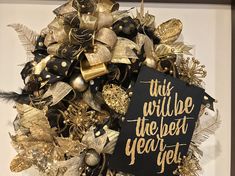 this will be the best year yet gold and black christmas wreath with holiday decorations on it