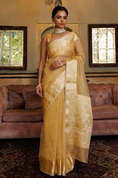 Dark gold saree with textured pattern and zari floral woven motifs on border. Comes with unstitched blouse piece. - Aza Fashions Gold Pre-draped Saree With Sheer Dupatta For Navratri, Festive Gold Pre-draped Cotton Silk Saree, Gold Cotton Silk Pre-draped Saree, Gold Pre-draped Saree With Cutdana For Navratri, Semi-stitched Gold Saree With Zari Work, Semi-stitched Gold Pre-draped Saree With Zari Work, Gold Raw Silk Pre-draped Saree With Zari Work, Gold Pre-draped Raw Silk Saree With Zari Work, Gold Pre-draped Saree With Dupatta In Cotton Silk