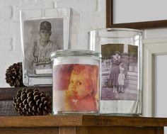 three glass jars with pictures and pine cones