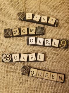 three scrabble tiles spelling the word'divya, mom, girl and queen '