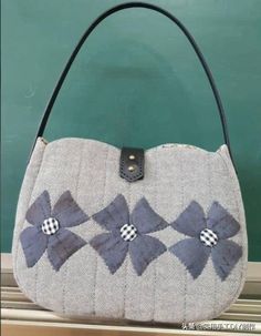 the purse is made out of fabric and has flowers on it, as well as leather handles