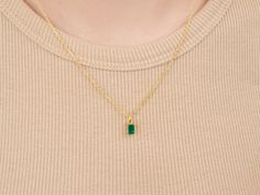 A dainty stone and delicate metallic chain are combined to create this Gold Pendant Necklace in bright emerald, your new favorite wear-anywhere accessory. The birthstone for the month of May is Emerald. This translucent green gemstone increases generosity, improves decision-making, and symbolizes compassion. High-quality lab-created emerald stone; Made of 14K gold-filled. Pendant size: 6mm x 4mm with 18" chain. Hypoallergenic, nickel, and lead-free; Tarnish resistant. Ideas to choose your Births Elegant Green Birthstone Necklace With Delicate Chain, Dainty Emerald Pendant Necklace With Delicate Chain, Emerald Necklace With Delicate Chain For Gift, Emerald Necklace With Delicate Chain As Gift, Emerald Jewelry With Delicate Chain As Gift, Emerald Jewelry With Delicate Chain For Gift, Dainty Gold Emerald Birthstone Necklace, Everyday Green Birthstone Necklace, May Birthstone Emerald Pendant Necklace With Adjustable Chain