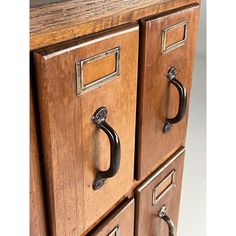 an old wooden cabinet with metal handles and knobs