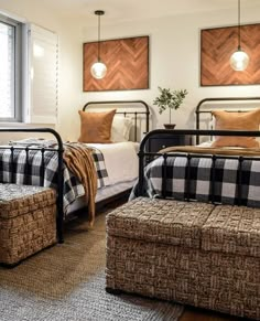 two beds in a bedroom with plaid blankets