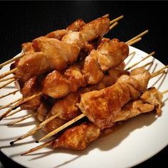 chicken skewers on a white plate with toothpicks