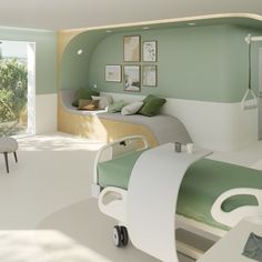 a hospital room with green and white decor on the walls, bed in the middle