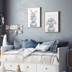 a bedroom with blue walls and pictures on the wall, including a white daybed